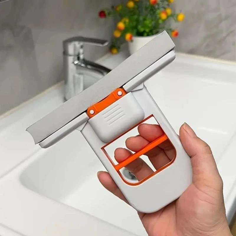 Hand holding white and orange foldable sponge mop with grey cleaning head